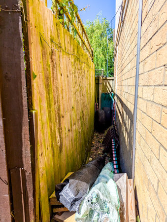 A small area down the side of a house which can be utilized for storing items such as wooden strips.の写真素材