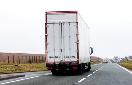 A large heavy goods vehicle travelling along a main road in the United Kingdom, on a journey to their next customer.の写真素材