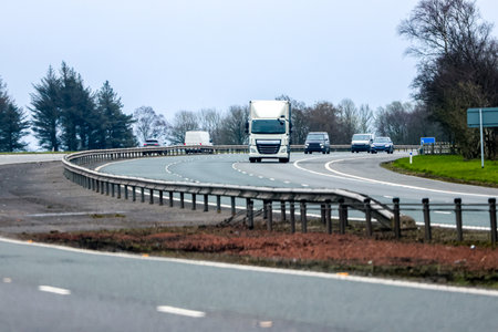 A large heavy goods vehicle travelling along a main road in the United Kingdom, on a journey to their next customer.の写真素材