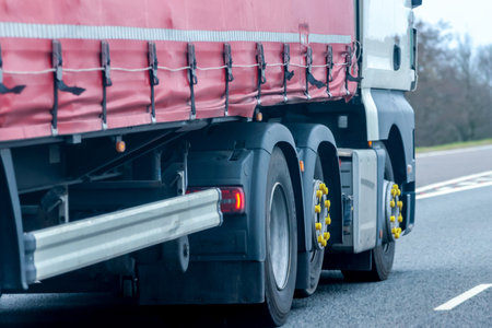 A large heavy goods vehicle travelling along a main road in the United Kingdom, on a journey to their next customer.の写真素材