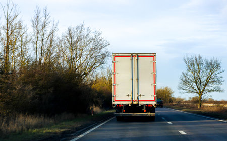 A large heavy goods vehicle travelling along a main road in the United Kingdom, on a journey to their next customer.の写真素材