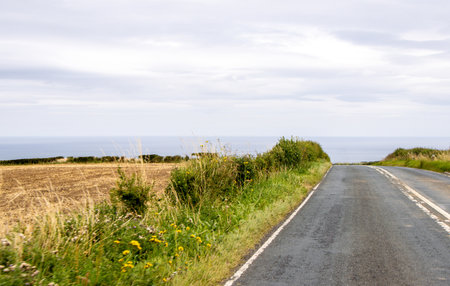 A dry day within the countryside as a vehicle drives along one of the thousands of country roads,...