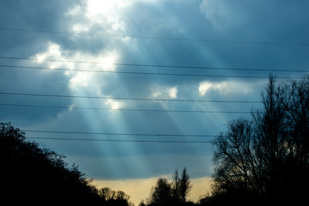 One of mother nature's beautiful spectacles with light beams lighting like a laser down to the ground from the skies above.の写真素材