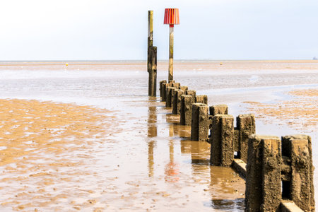 Sand Barriers Typically Seen Along Beach Locations To Prevent Large Sand Movement Occurring. The barriers prevent sand moving along with the tides or waves and building up elsewhere.の写真素材