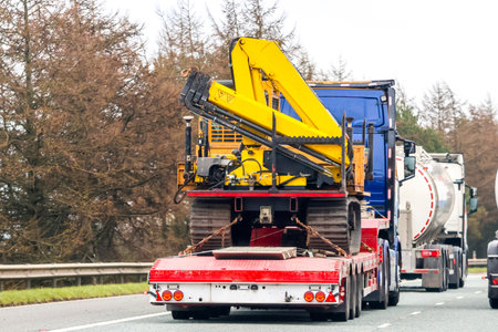A large heavy goods vehicle travelling along a main road in the United Kingdom, on a journey to their next customer.の写真素材