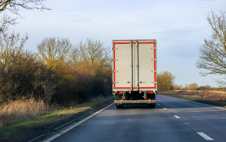 A large heavy goods vehicle travelling along a main road in the United Kingdom, on a journey to their next customer.の写真素材