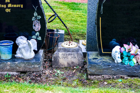 People of all ages and backgrounds are laid to rest in a cemetery, here seen headstones that are blank awaiting engraving.の写真素材