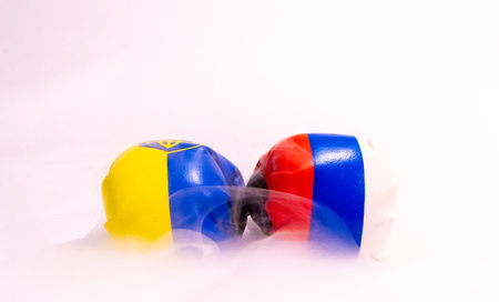 The long going war between Russia and Ukraine signified here by two boxing gloves with the country flags on them.の写真素材