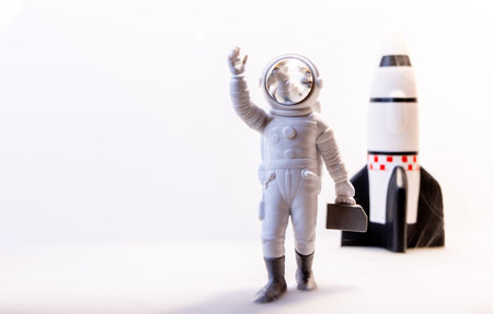 An Astronaut celebrates after some type of Space expedition that has been successful, with a large rocket behind them.の写真素材