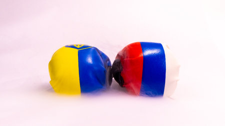 Two boxing gloves with the colors of two different country flags on them.の写真素材