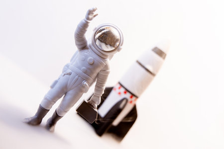 An Astronaut celebrates after some type of Space expedition that has been successful, with a large rocket behind them.の写真素材