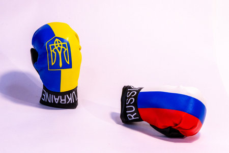 The long going conflict between Russia and Ukraine signified here by two boxing gloves with the country flags on them.の写真素材