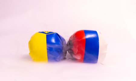 The long going war between Russia and Ukraine signified here by two boxing gloves with the country flags on them.の写真素材