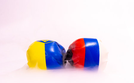The long going war between Russia and Ukraine signified here by two boxing gloves with the country flags on them.の写真素材