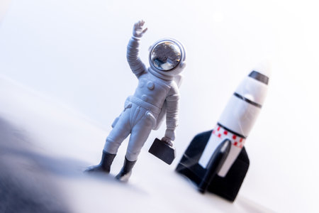 An Astronaut celebrates after some type of Space expedition that has been successful, with a large rocket behind them.の写真素材
