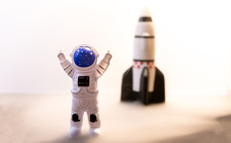 An Astronaut celebrates after some type of Space expedition that has been successful, with a large rocket behind them.の写真素材