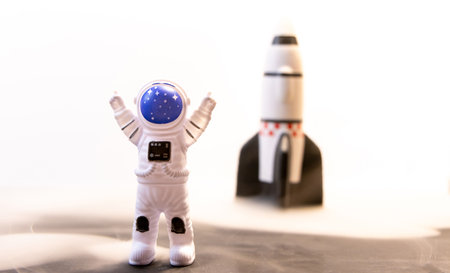 An Astronaut celebrates after some type of Space expedition that has been successful, with a large rocket behind them.の写真素材