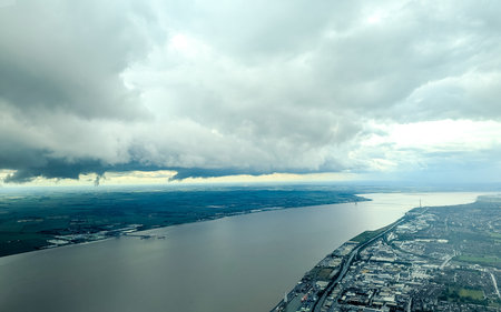 A passenger view from high above the earth's surface as an aircraft flies across the landscape.