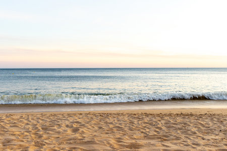 A stunning european sandy beach where holiday goers and locals go to enjoy the sand, sea and sun.の写真素材