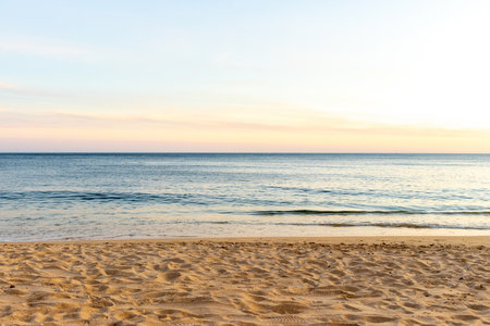 A stunning european sandy beach where holiday goers and locals go to enjoy the sand, sea and sun.の写真素材