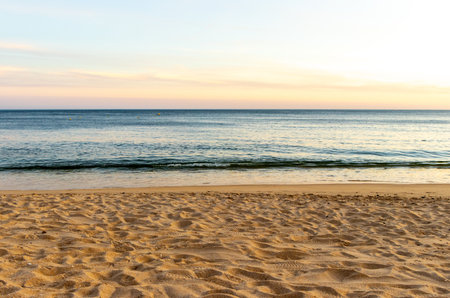A stunning european sandy beach where holiday goers and locals go to enjoy the sand, sea and sun.の写真素材