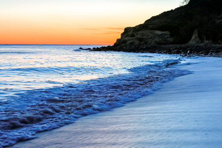 A stunning european sandy beach where holiday goers and locals go to enjoy the sand, sea and sun.の写真素材