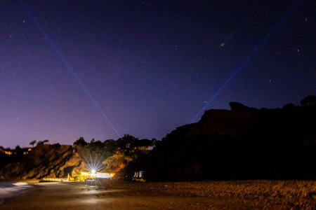 A beautiful night beach setting with the colourful skies and stars over the seafront of a European coastline.の写真素材