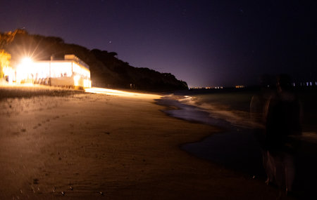 A beautiful night beach setting with the colourful skies and stars over the seafront of a European coastline.の写真素材