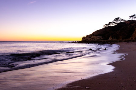 A stunning european sandy beach where holiday goers and locals go to enjoy the sand, sea and sun.の写真素材