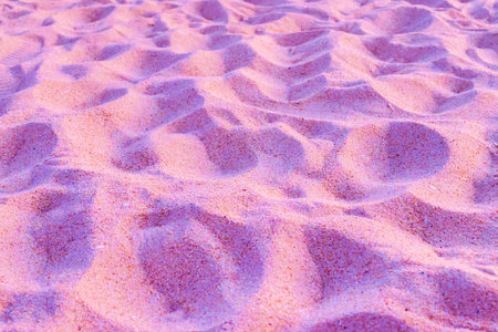 Pink sands founds often on exotic or european beaches where people like to walk, sunbath and play in the sand.の写真素材