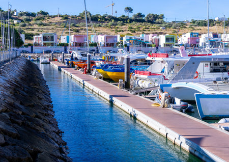 A motorboat moored up in a sunny marina ready for it's owner to return and use it.の写真素材