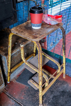 A wooden manmade chair where people sit to rest or to eat and drink.