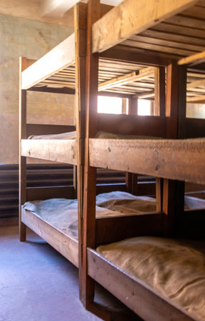 Prisoner of war camp buildings which were once used to house thousands of prisoners of war. The beds where prisoners used to try and get rest.の写真素材