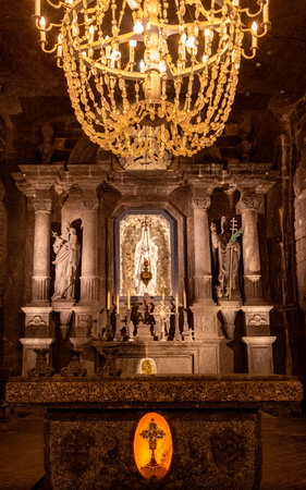 The Salt Mines of Poland have hundreds of miles of features and hidden amazing sights, usually occupied by tourists from around the world. Here seen the large chandelier that brings to life one of the large chambers.の写真素材