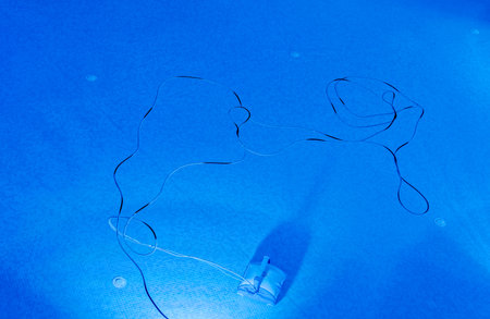 A small robot at the bottom of a resort swimming pool works through the night to clean the dirt etc for the next day's swimmers.の写真素材