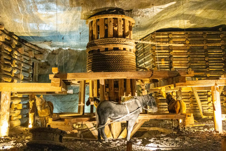 The Salt Mines or Poland have hundreds of miles of features and hidden amazing sights, usually occupied by tourists from around the world. Here seen just one of the many pulley systems that was used to lift bucket loads of salt and other minerals.の写真素材