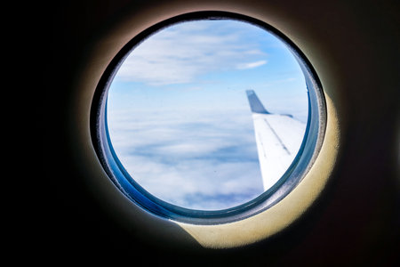 A passenger view from high above the earth's surface as an aircraft flies across the landscape.