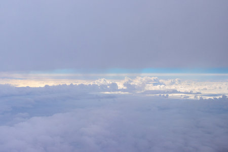 A passenger view from high above the earth's surface as an aircraft flies across the landscape.