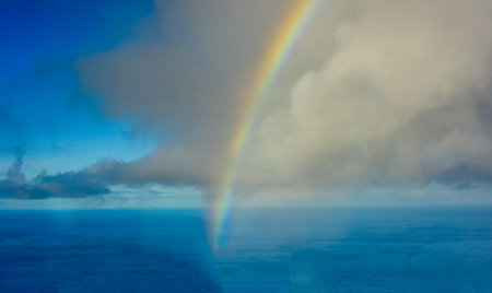 One of Earth's natural wonders, a rainbow with various colours in an arch for all to enjoy who can see it.の写真素材