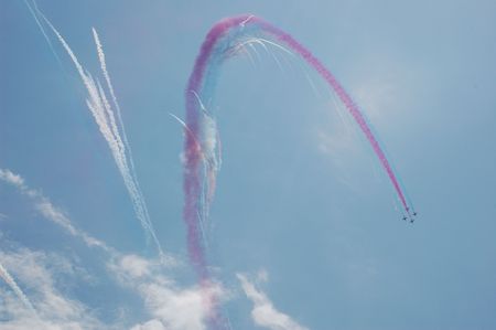 Fighters link with colored smoke trace 