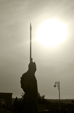 Statue of ancient warrior on sun background, in Gala fortress near Baku, Azerbaijan.のeditorial素材