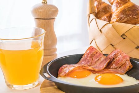 (Breakfast image) fried egg and croissantsの写真素材