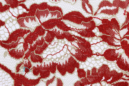 The macro shot of the red and beige lace texture materialの写真素材