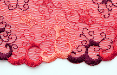 The macro shot of the red and orange lace texture materiaの写真素材