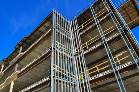 Concrete and steel frame multi story medical facility under construction in urban area.