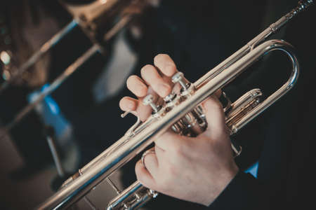 Jazz Musicians. Close-up of brass instruments. Trumpet. French Horn Close up of musicians' hands.の写真素材