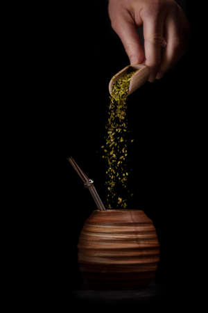 Beautiful yerba pot. Clay Matero. Side view on black background. Space for textの写真素材