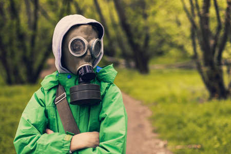 Man escaping a pandemic. Hiding in the woods wearing a gas mask. Covid19の写真素材