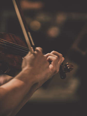 Closeup for the violin and the violinist's hand. Symphony Orchestraの写真素材