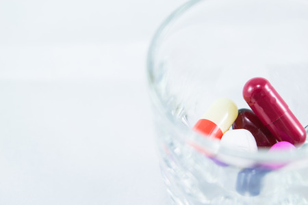Measuring glass with capsules and tablets 